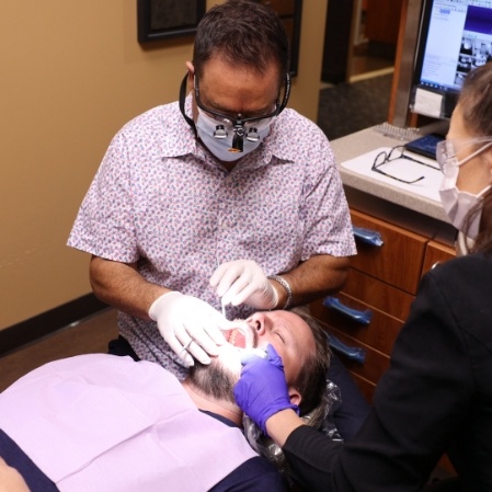 Dentist placing dental sealants