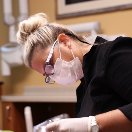 Dental team member providing dental services